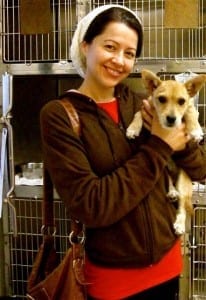 Melissa Huggins at an animal shelter holding a puppy. 