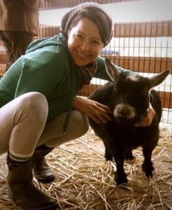 Photo of Melissa Huggins at a farm sanctuary. 