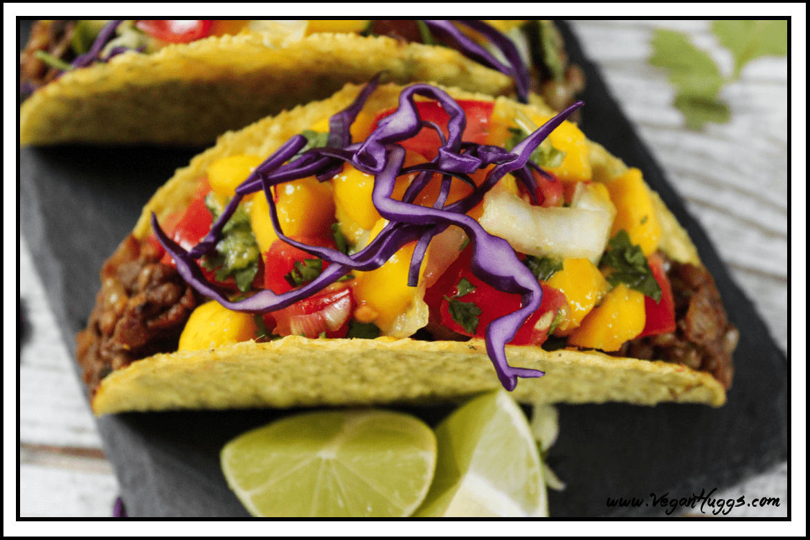 Overhead view of one mushroom tacos on a slate board. 