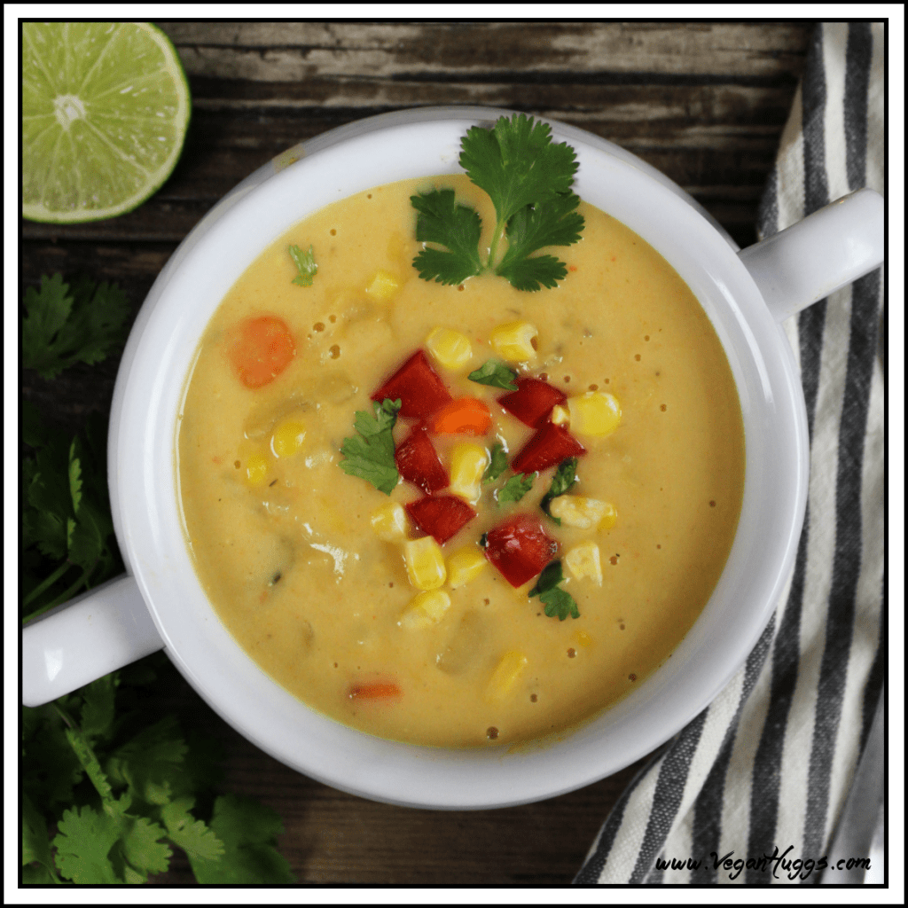 Overhead view of potato corn chowder in a white bowl topped with fresh cilantro.