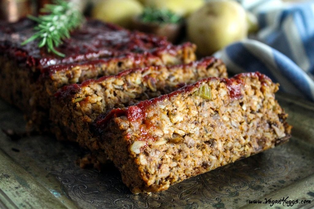 Side view of meatless loaf on a silver serving tray. Cut into slices