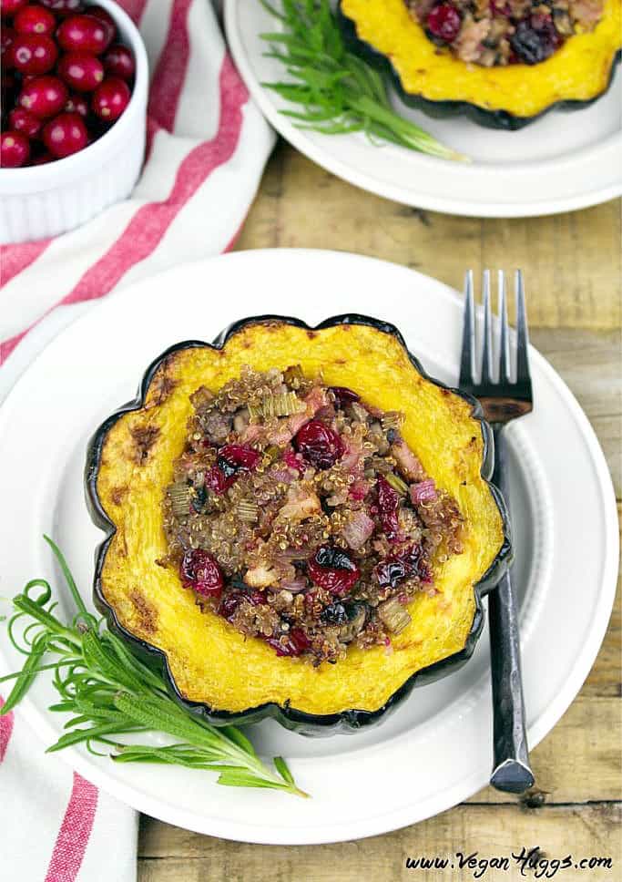 two plate with stuffed acorn squash on top. Striped napkin on the side. 