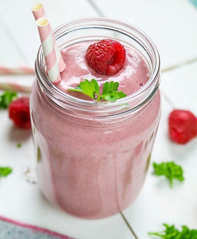 Overhead view of banana berry smoothie in a glass jar. 