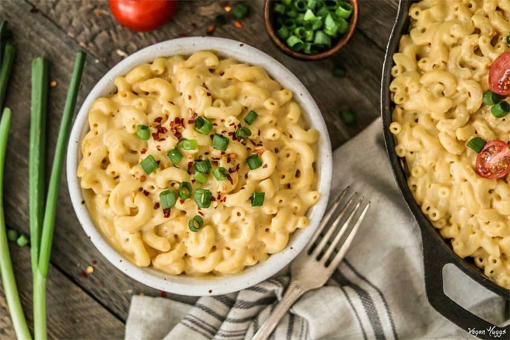 Vegan Mac and Cheese in white bowl topped with green onions.