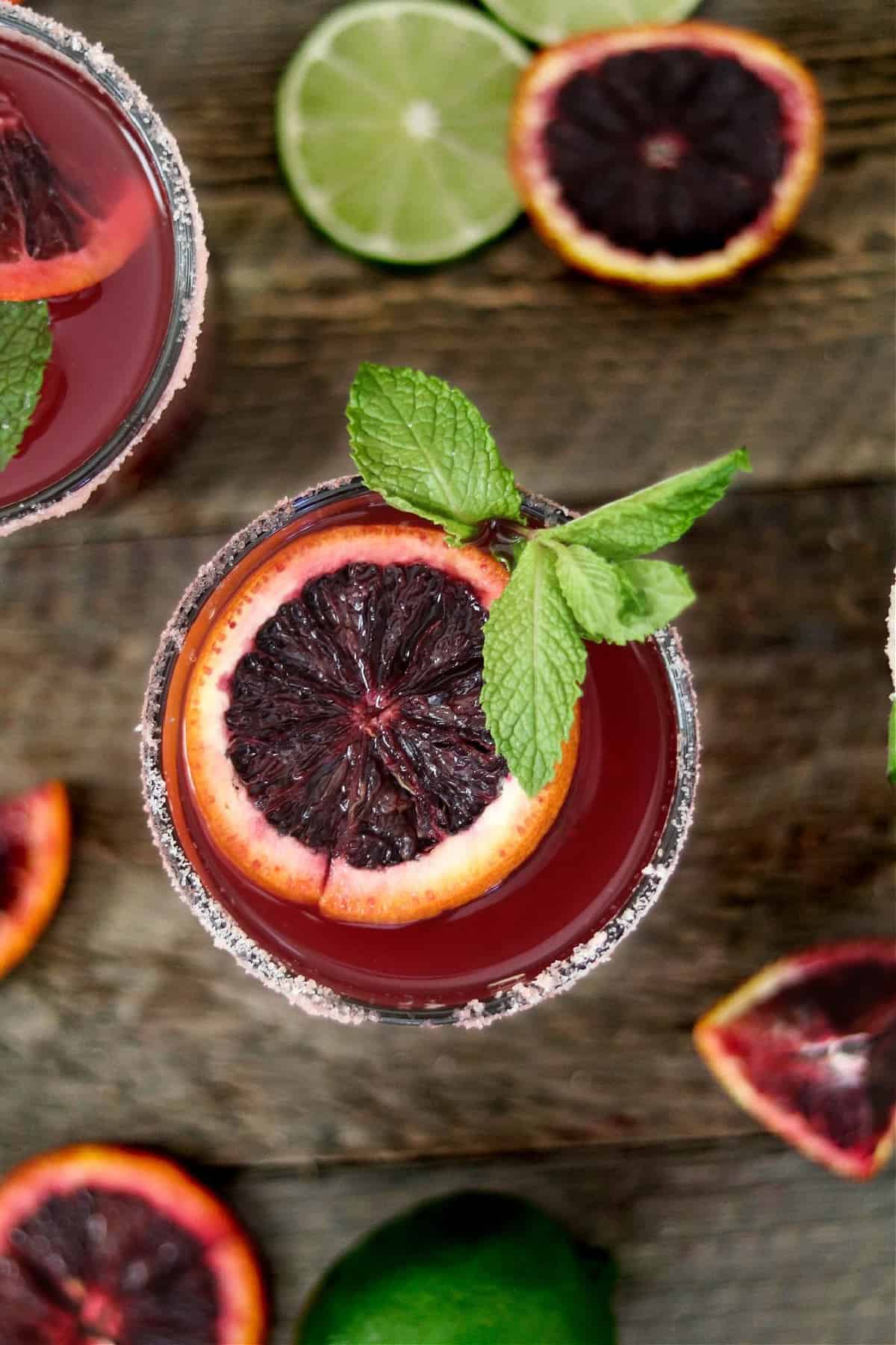 overhead view of a blood orange margarita in a glass.