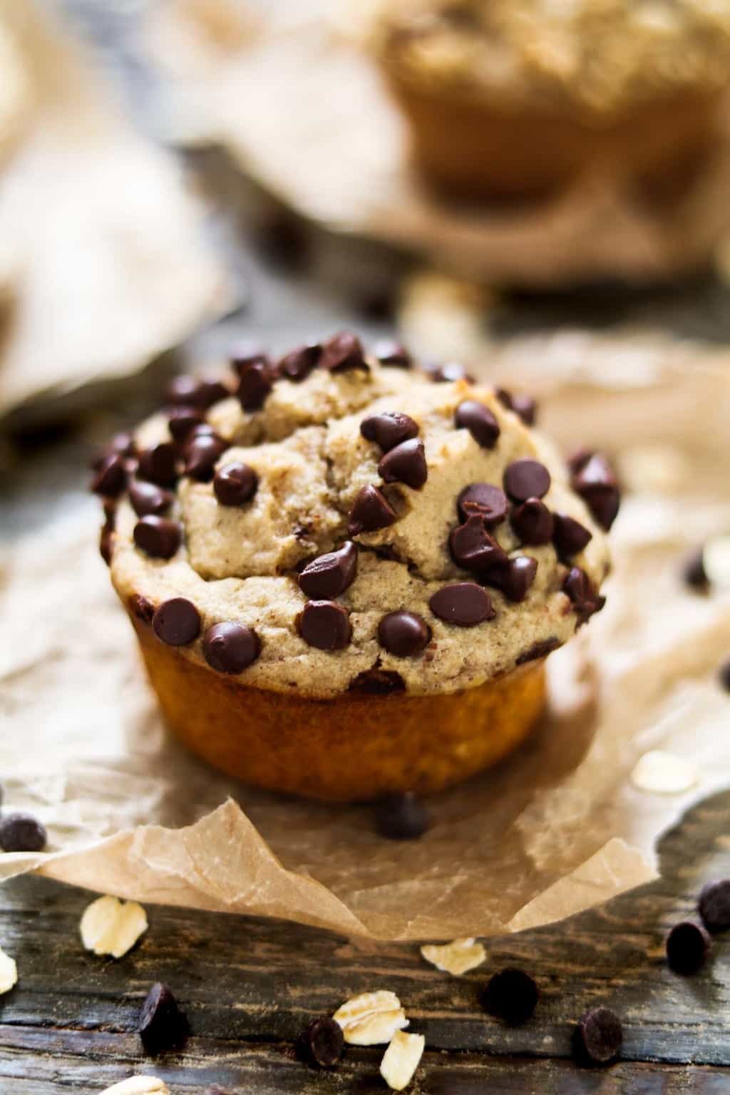 chocolate chip protein muffin on a piece of parchment paper. 