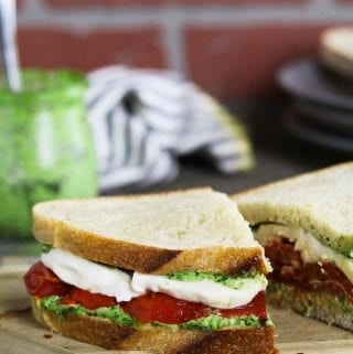 This Roasted Red Pepper Sandwich is built with three layers of deliciousness...creamy vegan mozzarella, cheesy pesto & smoky-sweet peppers.