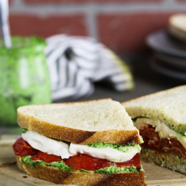 This Roasted Red Pepper Sandwich is built with three layers of deliciousness...creamy vegan mozzarella, cheesy pesto & smoky-sweet peppers.