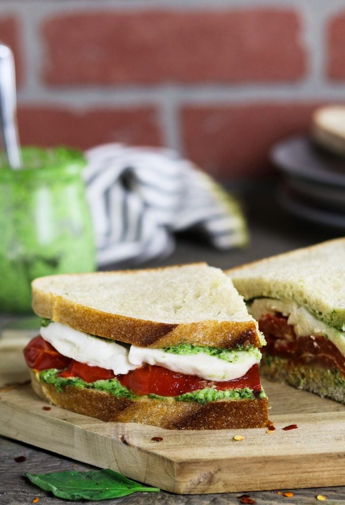 This Roasted Red Pepper Sandwich is built with three layers of deliciousness...creamy vegan mozzarella, cheesy pesto & smoky-sweet peppers.