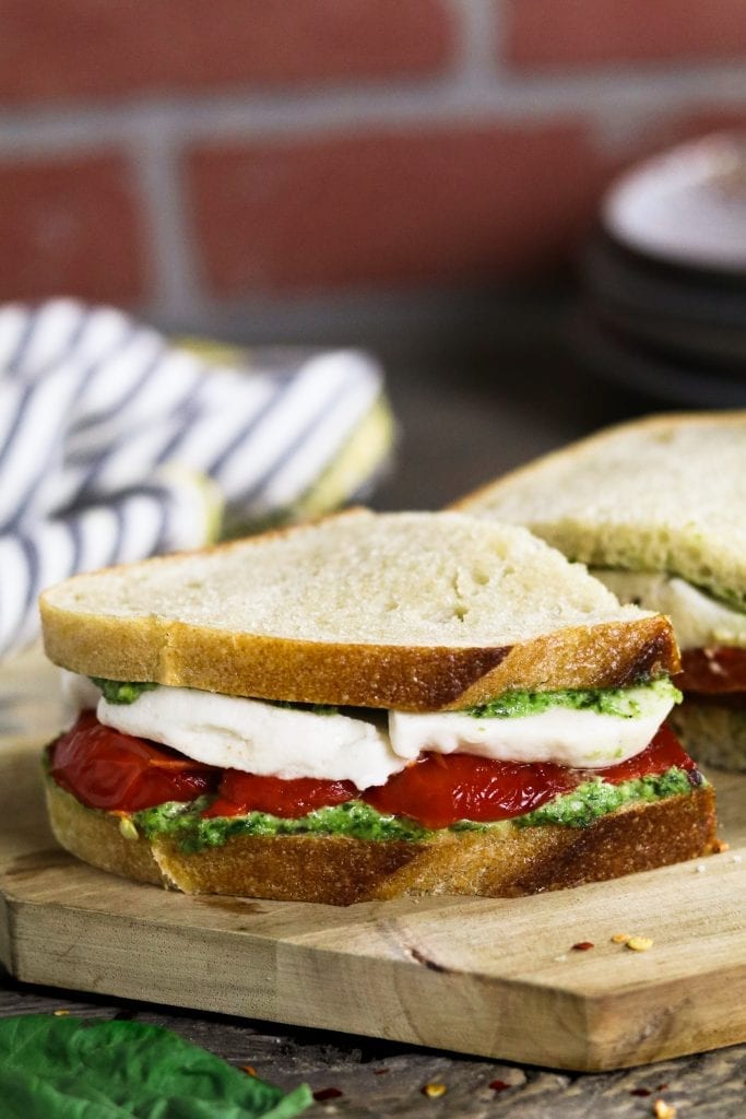 This Roasted Red Pepper Sandwich is built with three layers of deliciousness...creamy vegan mozzarella, cheesy pesto & smoky-sweet peppers.