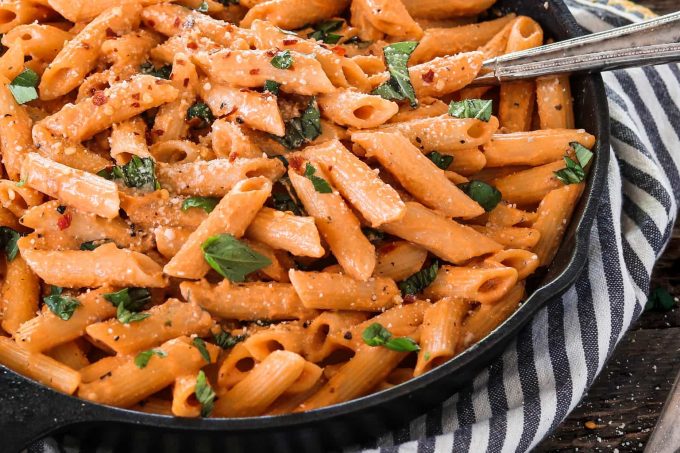 close up view of pasta in a cast iron pan. 