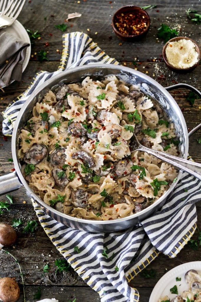 Vegan Mushroom Stroganoff in a large pan on top of a striped napkin