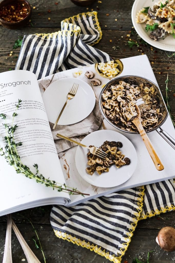 Opened Frugal Vegan Cookbook on a striped napkin. 