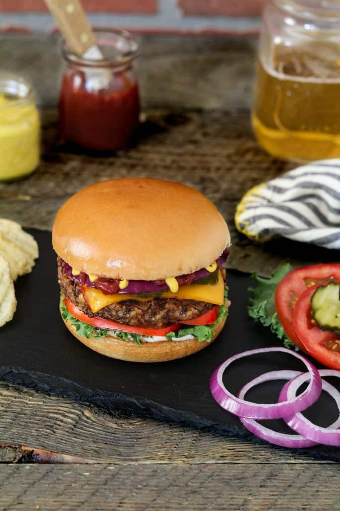 Bean and Mushroom Burger with onion, pickles and tomato on the side. 