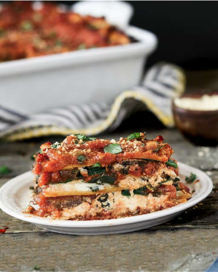 Slice of vegan lasagna on a white plate.