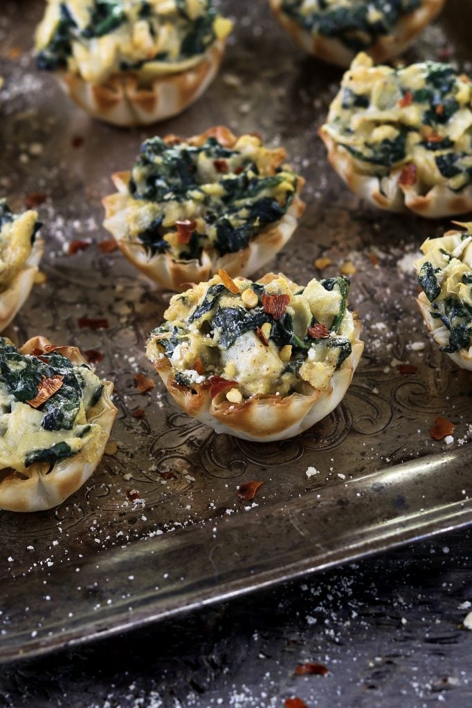 Fully baked Vegan Spinach Artichoke Cups on a silver tray.
