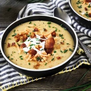 Horizontal photo of two bowls of vegan baked potato soup