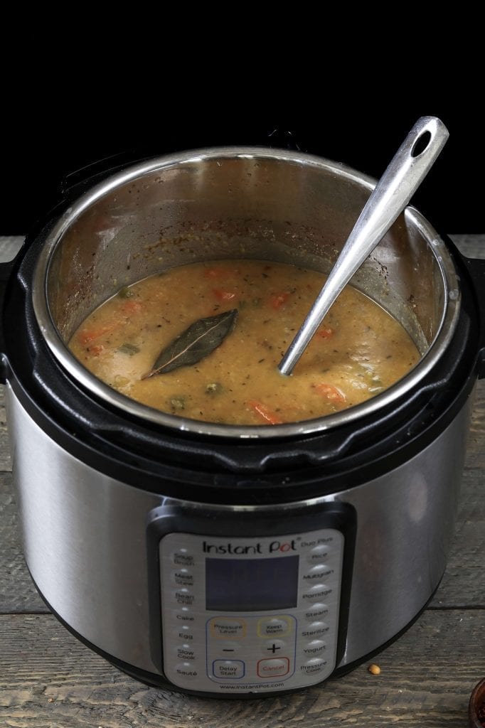 Fully cooked Yellow Split Pea Soup in the Instant Pot with a ladle inside.