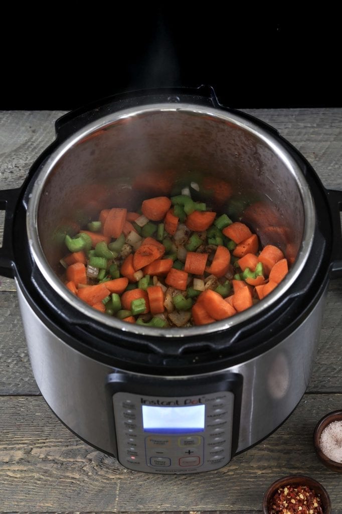 cooking onions, seasonings, celery and carrots in the instant pot. 