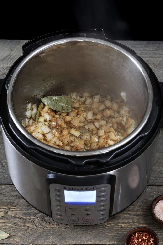 sauteing onions with seasonings to make yellow split pea soup.
