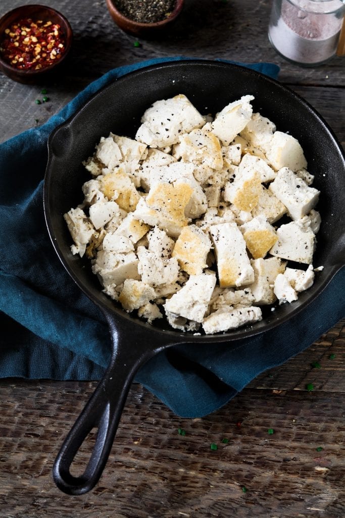 Tofu browned in a cast iron skillet