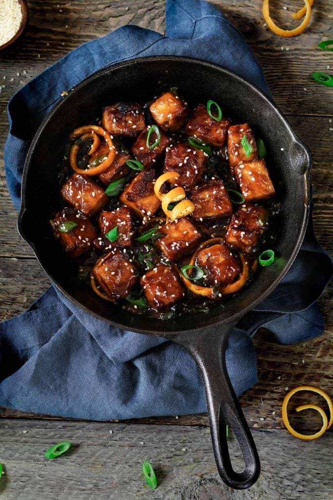 Overhead view of general tsos tofu in a cast iron skillet. 
