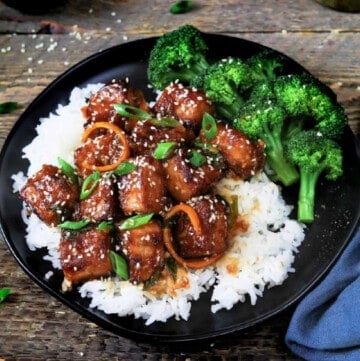 general tso's tofu on a plate with broccoli and rice.