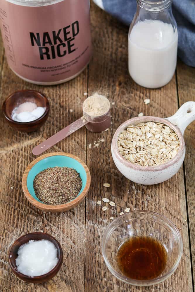 All ingredients for vegan protein pancakes on a wooden table. Blue napkin in the background. 