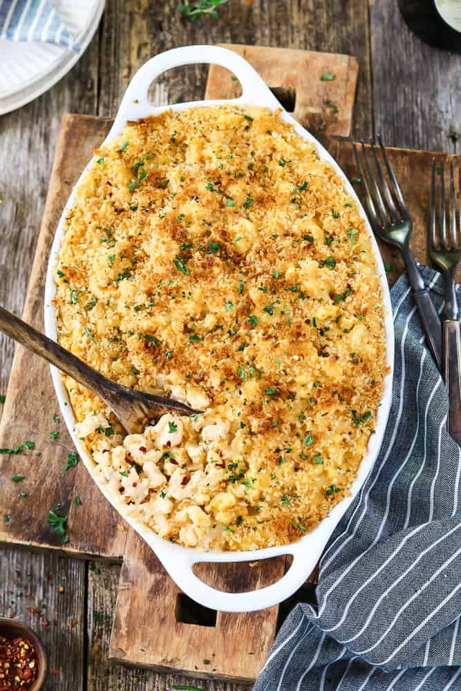 overhead view of baked vegan mac and cheese in a white casserole dish.