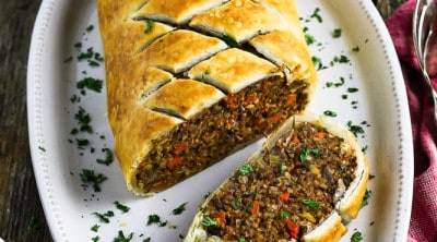 fully baked and cut vegan wellington on a white serving platter