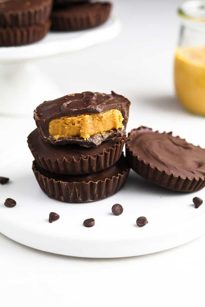 Vegan Peanut Butter Cups on a white plate with chocolate chips on the side. 