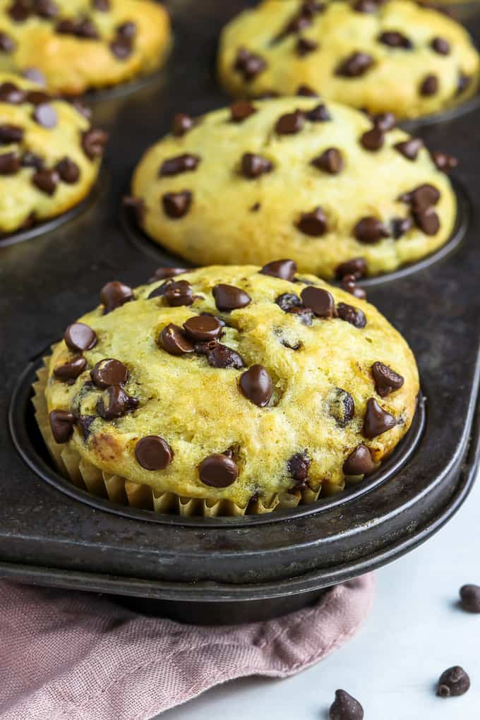 Muffin tin filled with fully baked vegan chocolate chip muffins. 