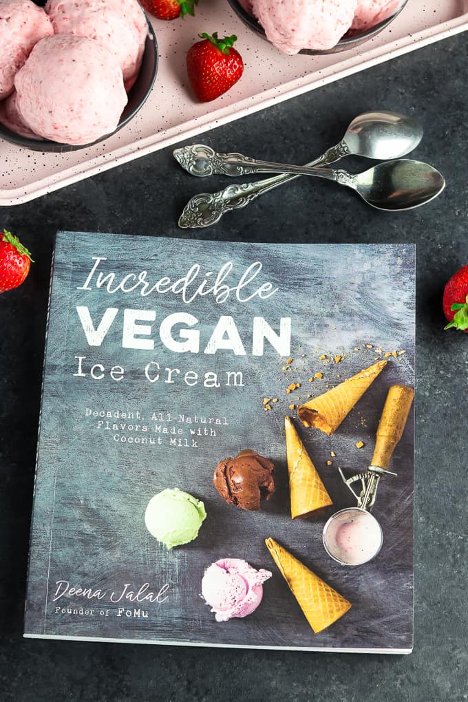 Photo of the Incredible Vegan Ice Cream Cook Book with spoons and ice cream on the table. 
