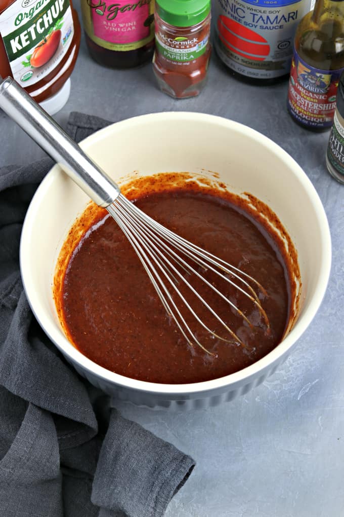 Bowl filled with sauce and a whisk inside.