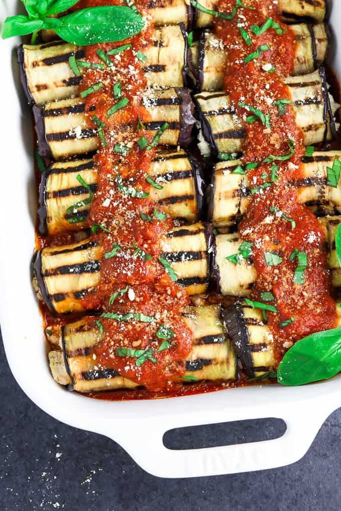 Casserole dish filled with fully cooked vegan eggplant rollatini. 