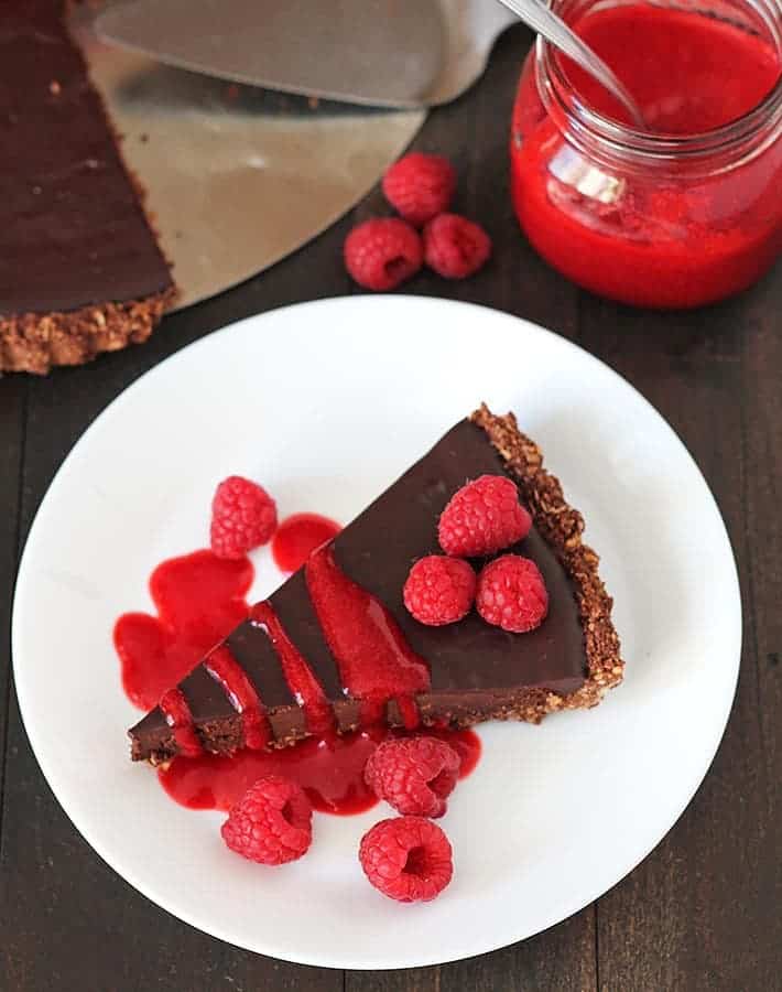chocolate tart of a white plate for vegan valentine's day recipes roundup.