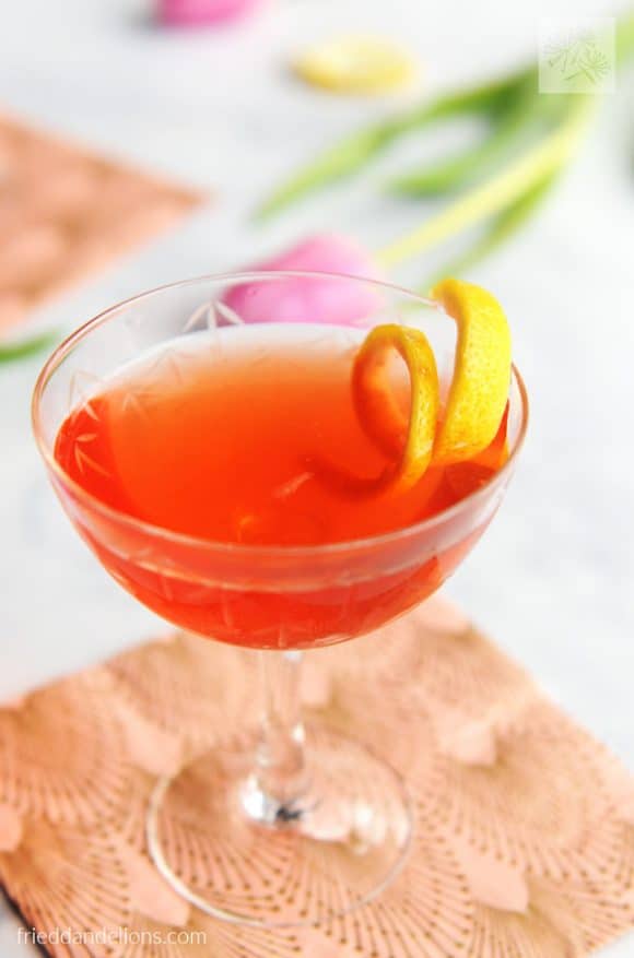 rose cocktail with a lemon twist on top.