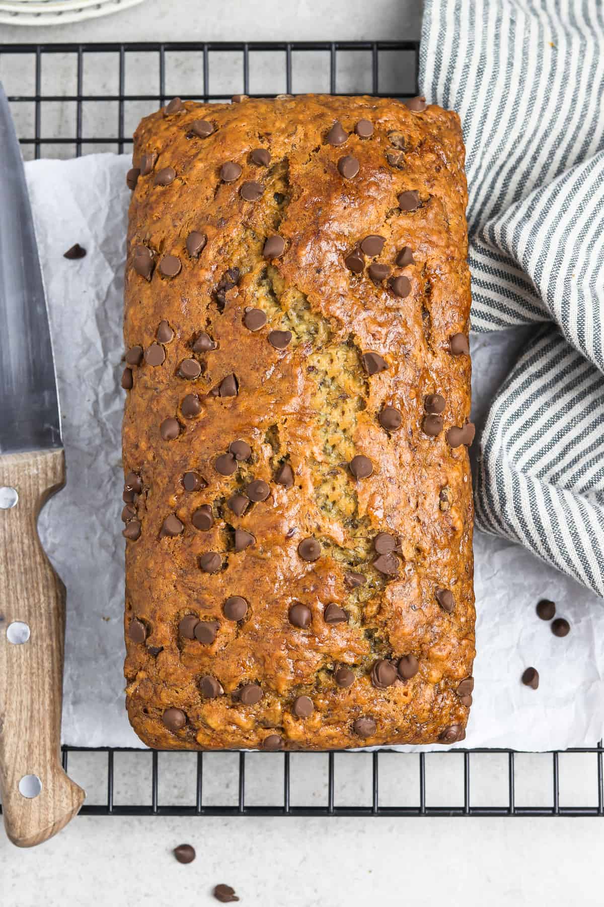 Overhead view of fully baked vegan banana bread on a cooling rack. 