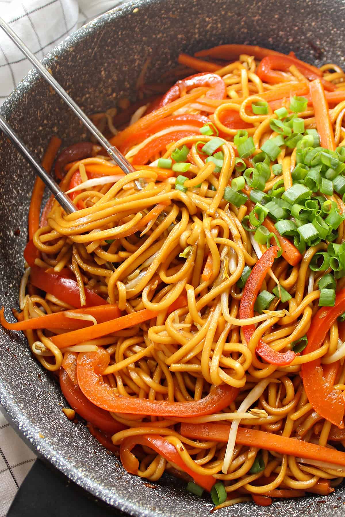 Closeup view of lo mein in a wok.