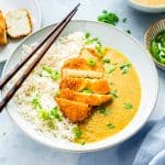 tofu katsu curry in a white bowl with chopsticks on top.