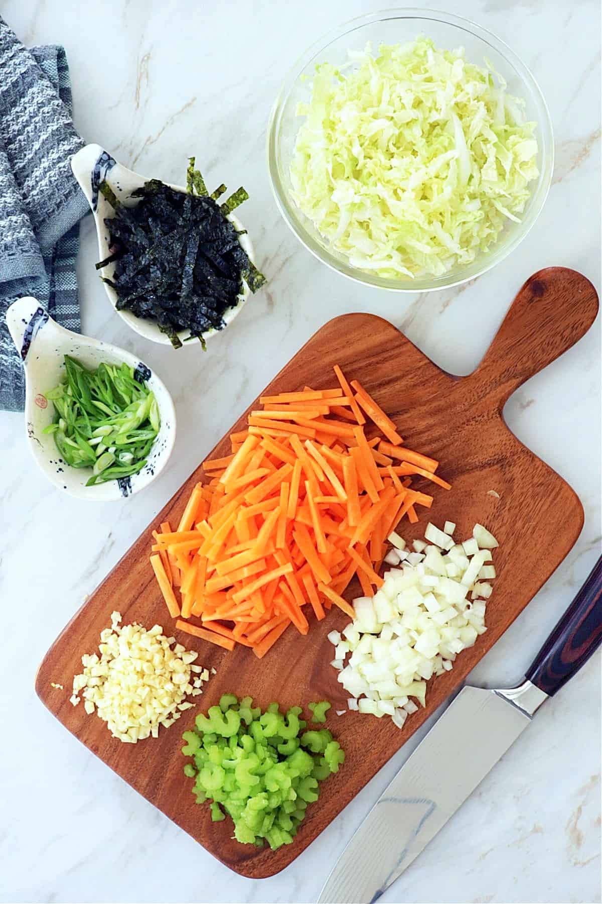 Cut and prepped ingredients on a wood cutting board. 