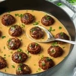 vegan Swedish meatballs in a gray pan filled with gravy