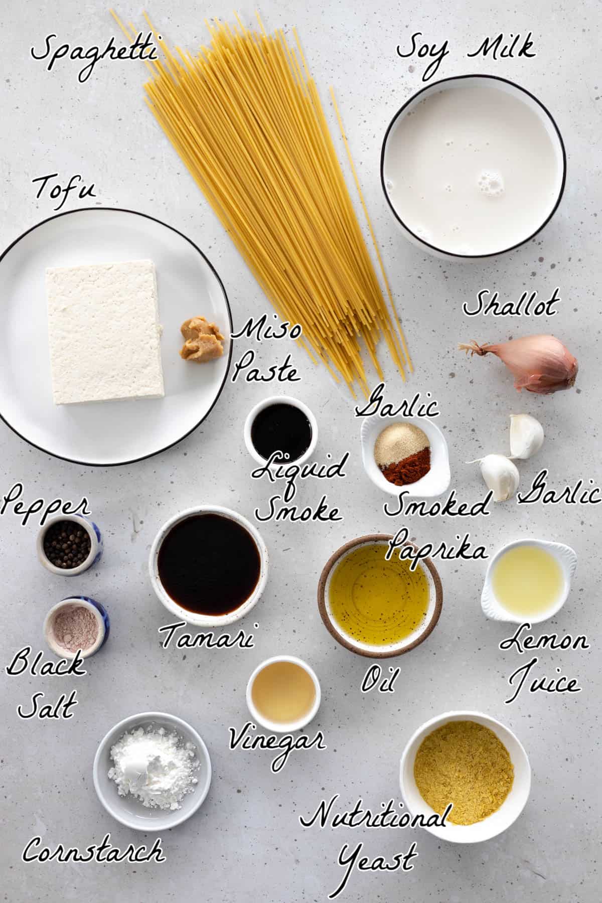 All ingredients to make carbonara on a stone table top. 