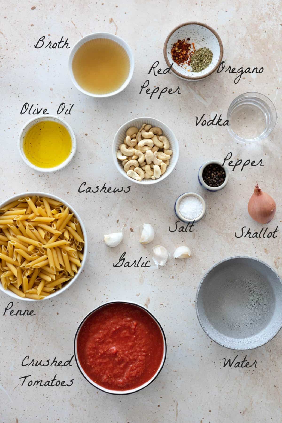 Ingredients to make the pasta recipe on a stone table. 