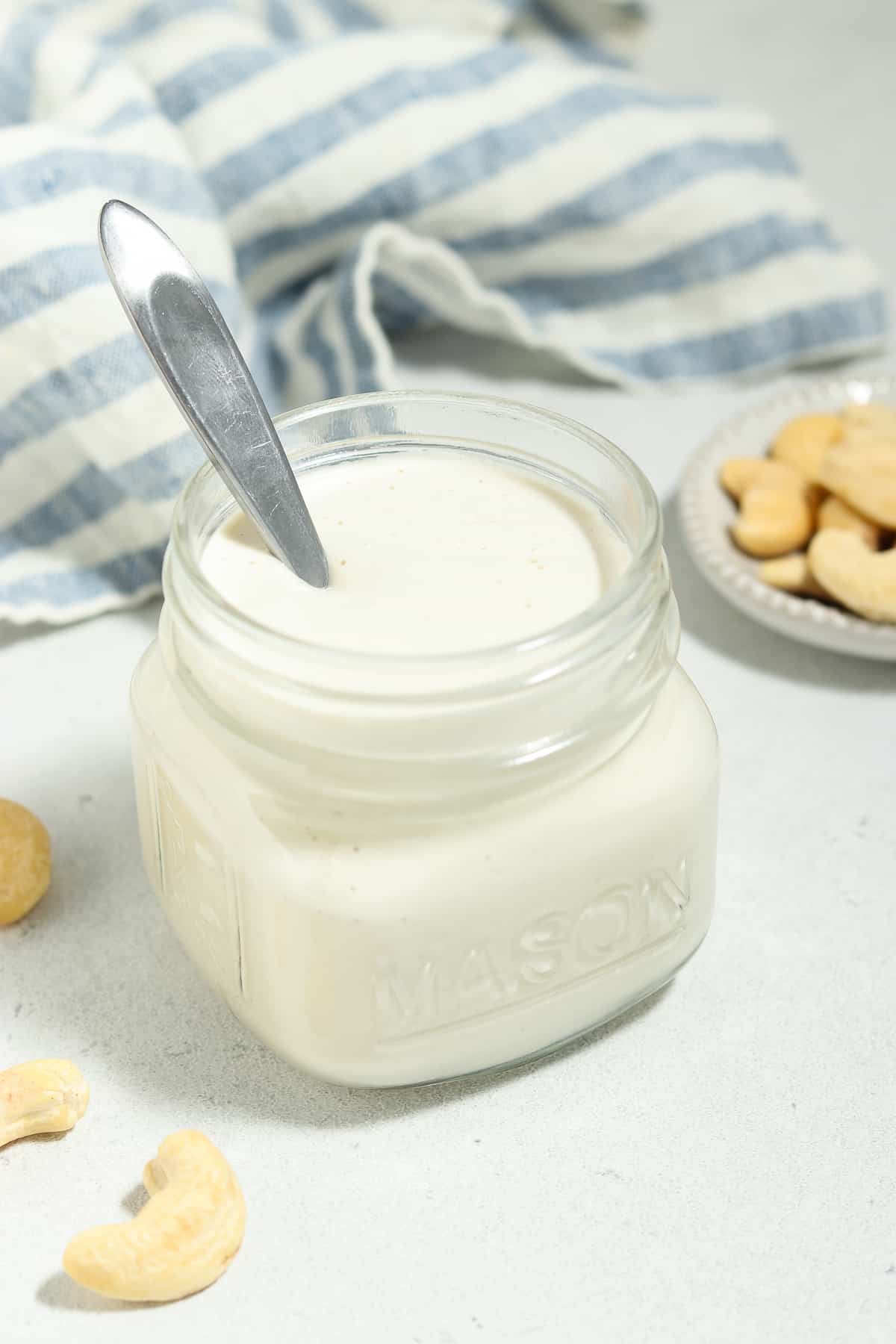 non-dairy cream in a mason jar with a spoon inside. 