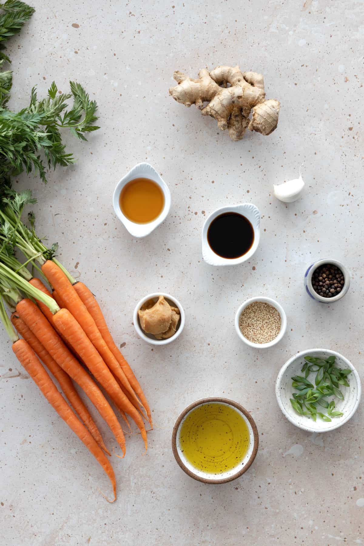 All ingredients to make carrots on a stone table top. 