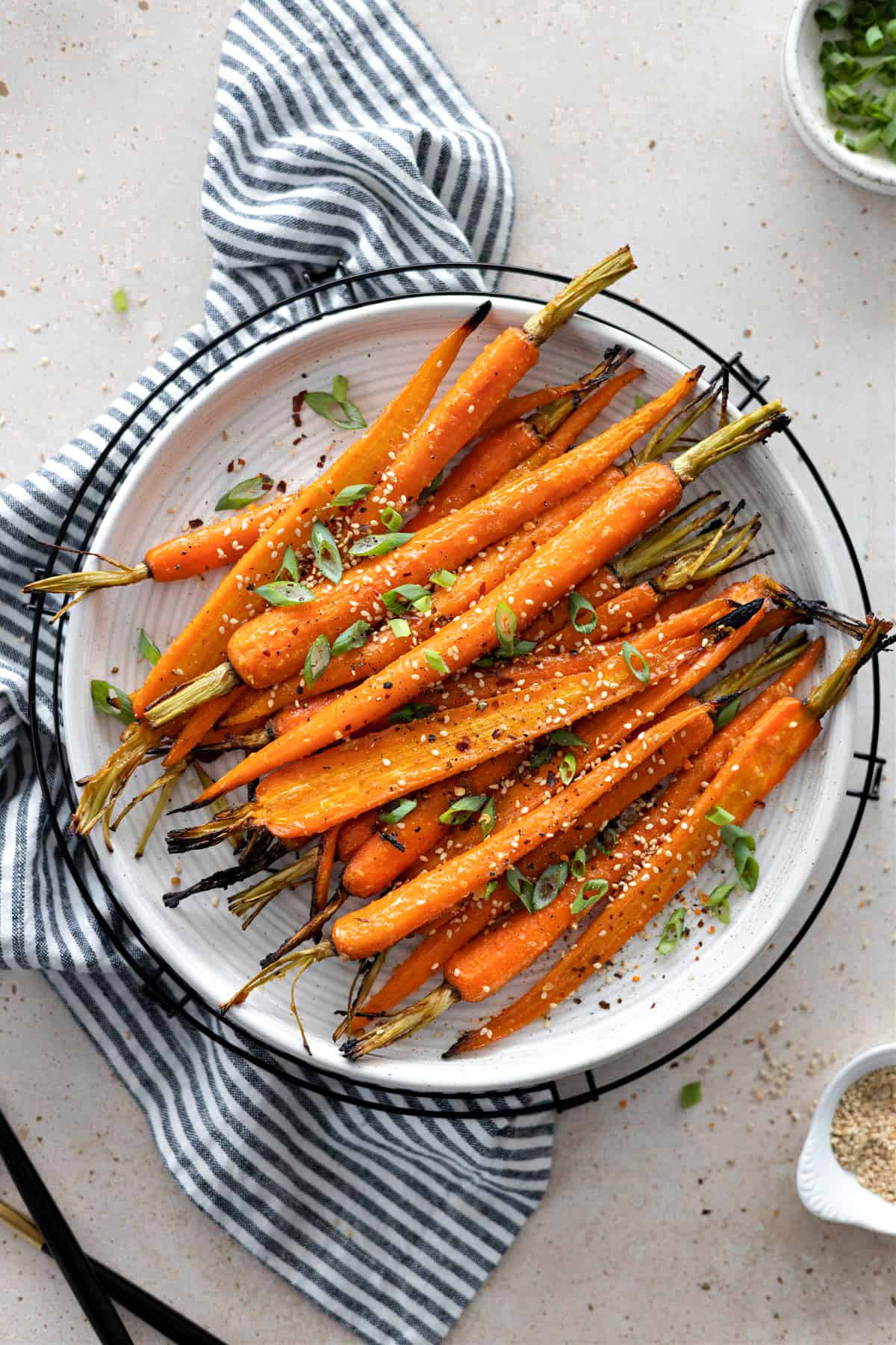 Overhead view of miso glazed carrots on a white plate.