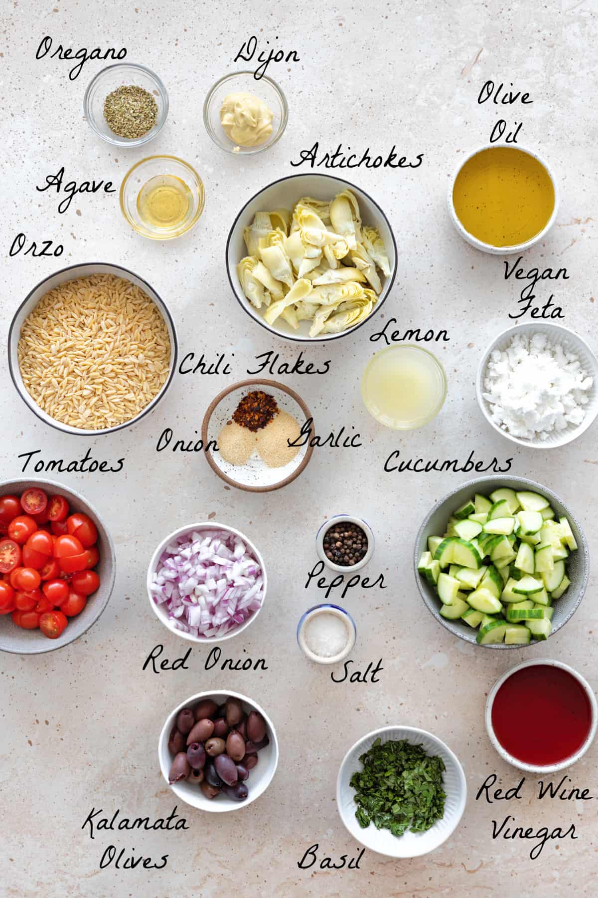 Ingredients to make orzo salad on a table top.