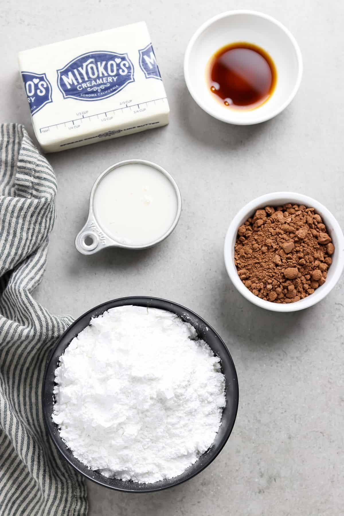 All ingredients to make frosting on a gray table top. 