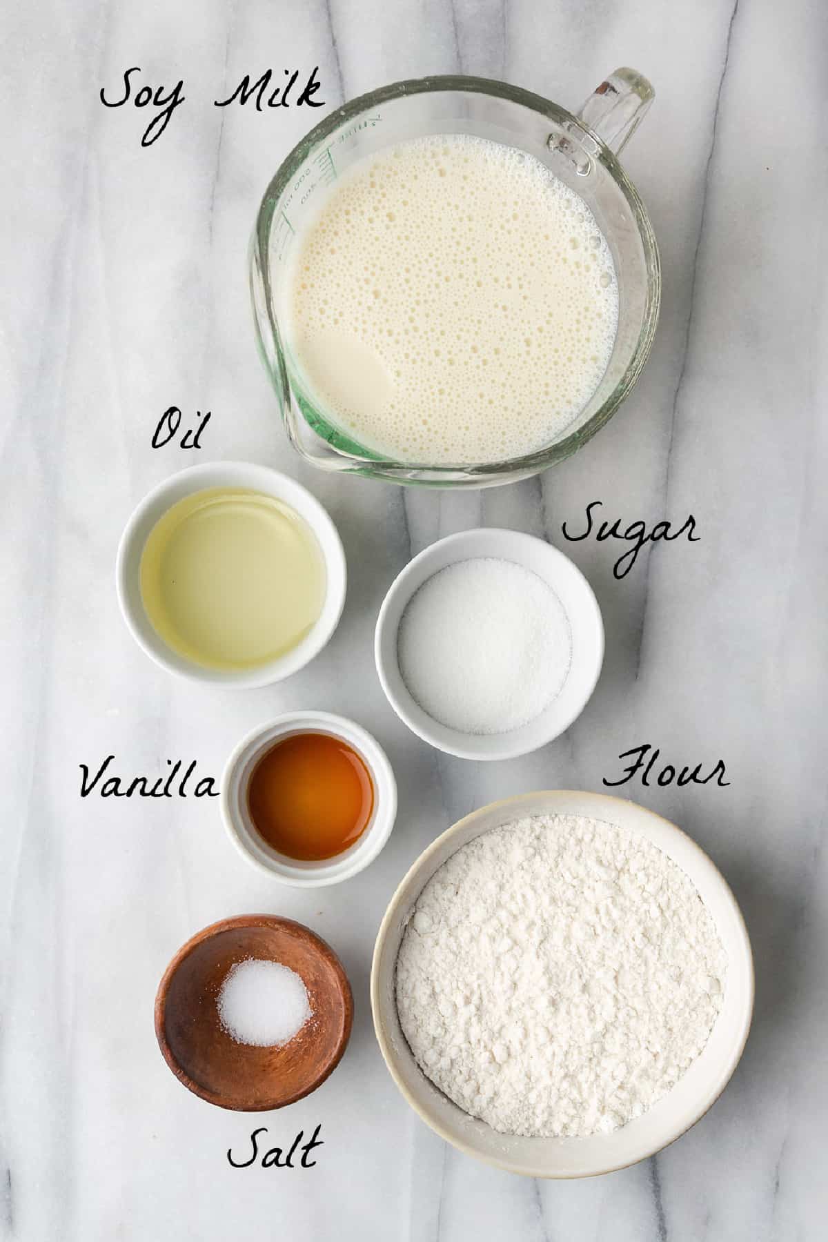 Ingredients required to make crepes on a marble table. 